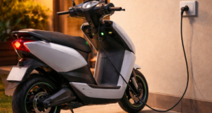 Electric scooter plugged into a standard home wall socket for overnight charging.
