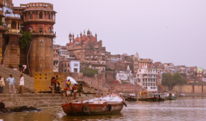 Devotees walking through the golden-domed Kashi Vishwanath Corridor towards the Ganga river.