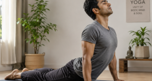 A person practicing Hatha Yoga Cobra pose on a mat for physical flexibility and strength.
