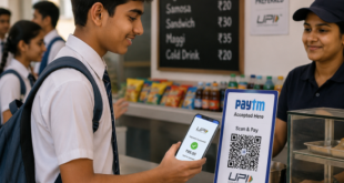 A teenager making a quick contactless UPI QR code payment via a smartphone at a school canteen.