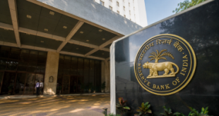 Exterior view of the Reserve Bank of India (RBI) headquarters building in Mumbai, featuring the central bank's official seal and entrance.