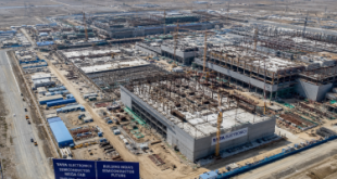 Aerial view of the massive construction site of the Tata Electronics semiconductor mega-fab facility showing cleanroom structural foundations in Dholera, Gujarat.