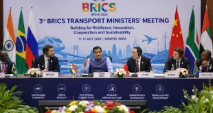 Union Minister Nitin Gadkari chairing the 3rd BRICS Transport Ministers Meeting in Nagpur India, flanked by international delegates, discussing sustainable transport infrastructure.
