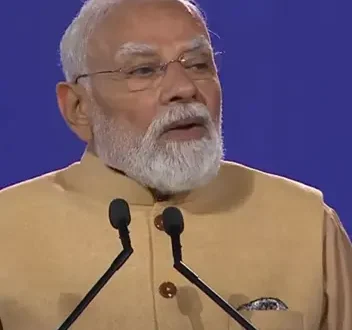 Prime Minister Narendra Modi speaking in Melbourne with futuristic 6G telecom towers, AI-powered digital networks, semiconductor chips and a smart city skyline representing India's 6G Vision and the future of telecommunications.
