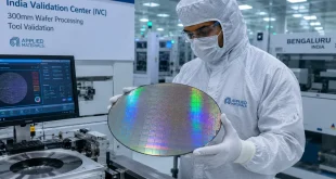 A engineer handling a high-precision 300mm silicon wafer inside a cleanroom environment for semiconductor manufacturing tool validation in Bengaluru.
